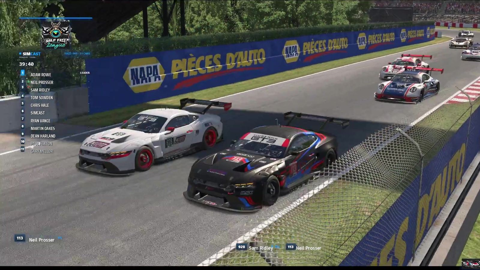 Two GT3 cars side by side into a corner at Circuit Gilles Villeneuve with four more
                cars up the road behind them, SimCast&rsquo;s timing tower down the left showing the
                full order, and the battle graphic naming both cars along the bottom.